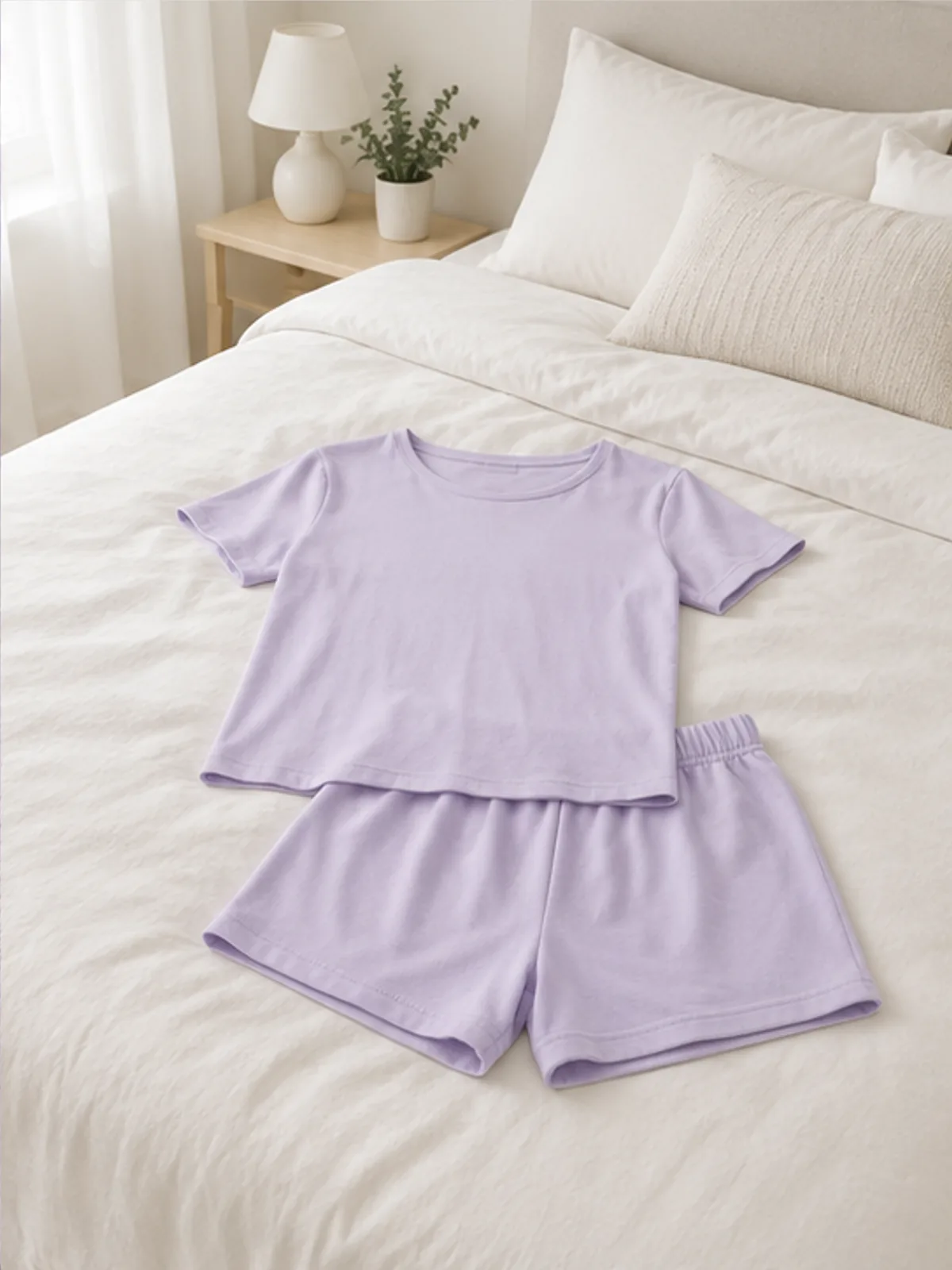 alba cotton set 4.webp alba cotton set laid over the end of a bed in a calm bedroom
