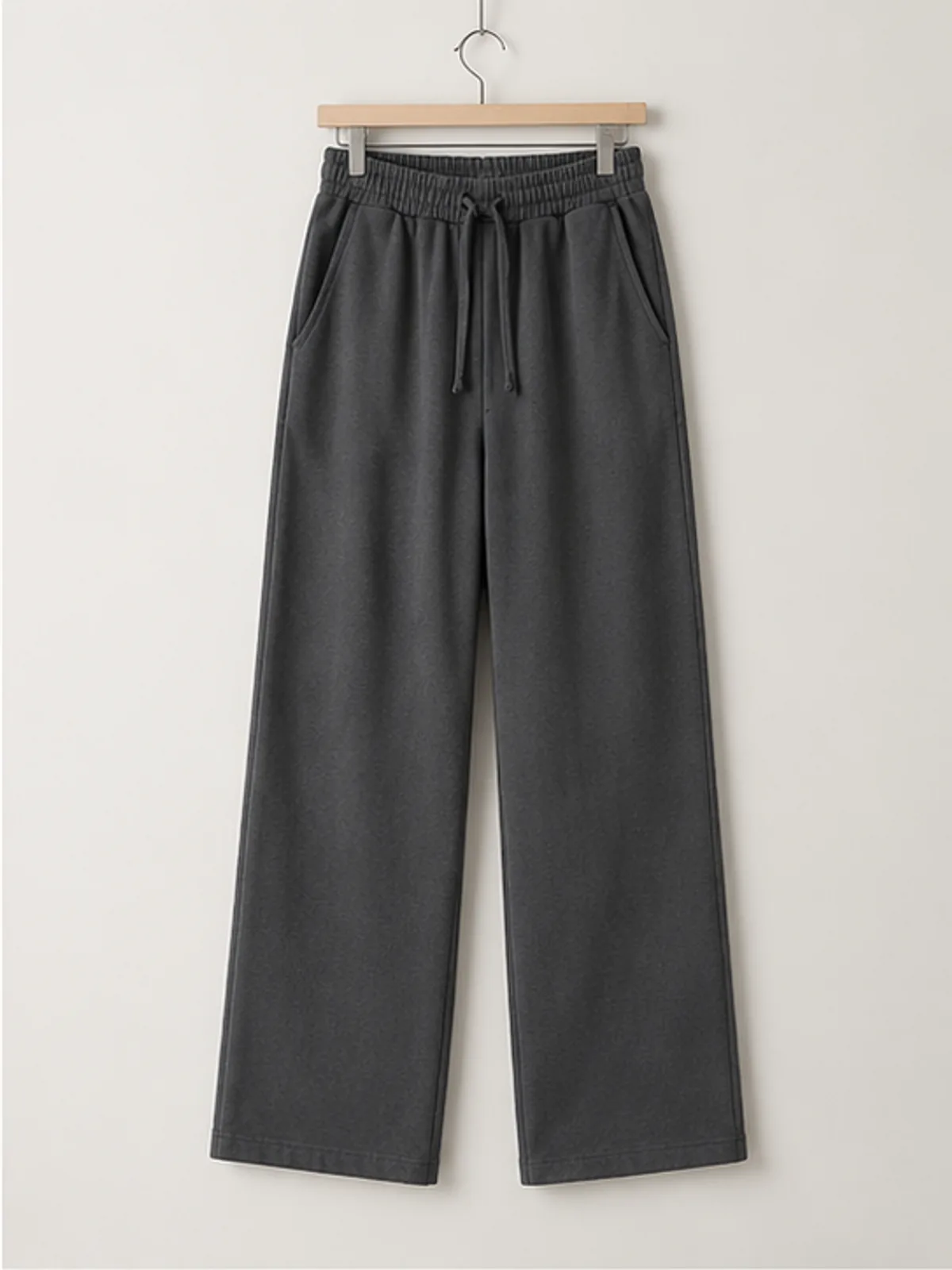 coast lounge pants 2.webp coast lounge pants hanging on a wooden hanger