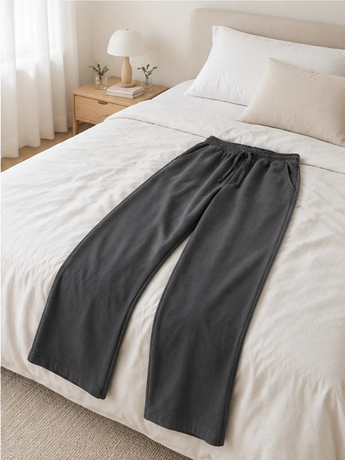 coast lounge pants 4.webp coast lounge pants laid over the end of a bed in a calm bedroom